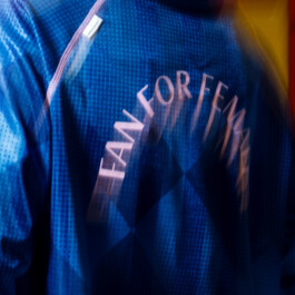 Blurred close-up of the blue campaign jersey with pink FAN FOR FEMALE lettering 