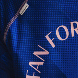 Detail of the jacquard fabric and embellished label on the Fan for Female jersey 