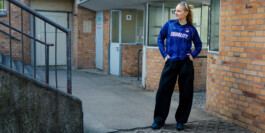Meira Werner in the blue Fan for Female jersey in front of a brick building 